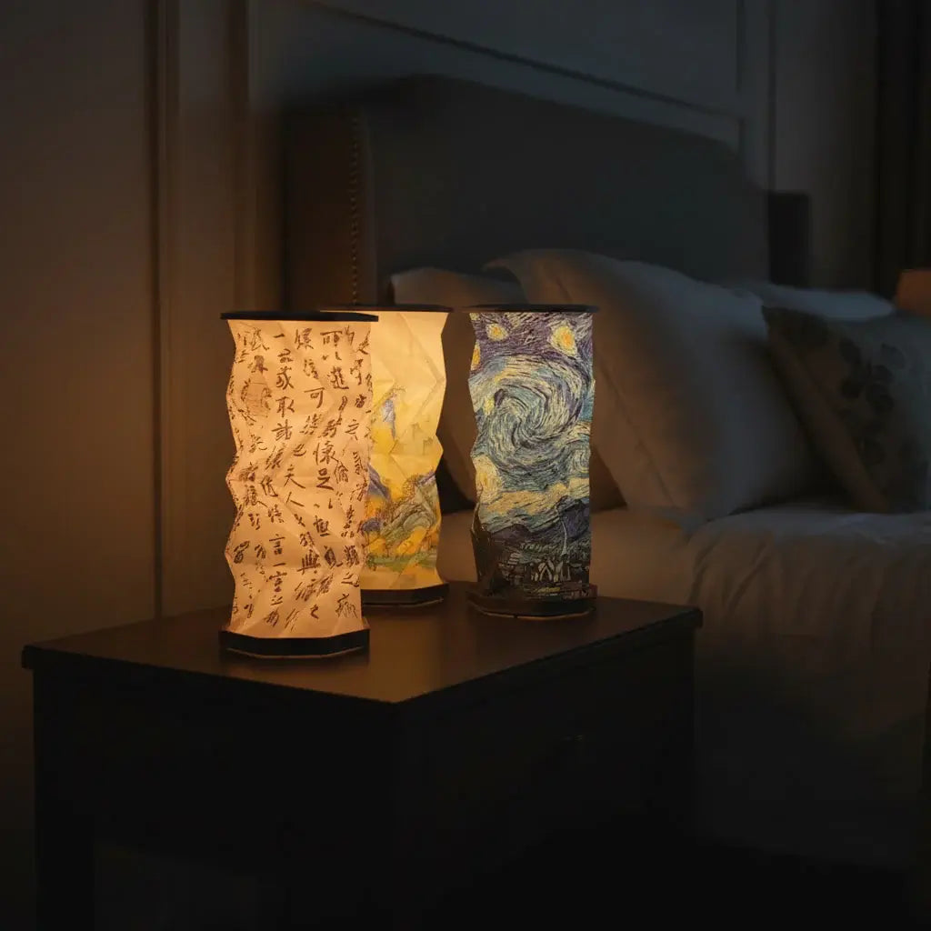 Artistic foldable accordion lamp with Chinese landscape and Van Gogh Starry Night print, glowing warm light on dark background