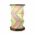 Walnut wood foldable geometric lamp with colorful chevron panel shade, warm glowing LED light