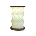 Walnut wood foldable geometric origami lamp with white paper shade, warm glowing LED light